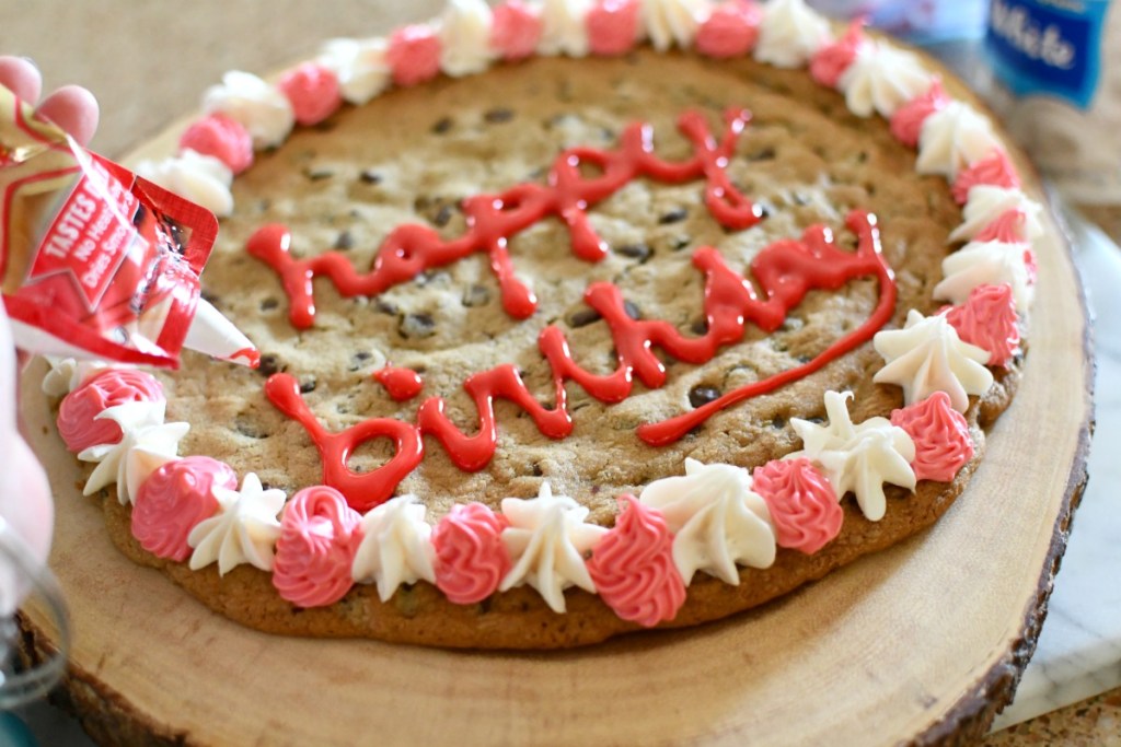 writing happy birthday on a cookie cake