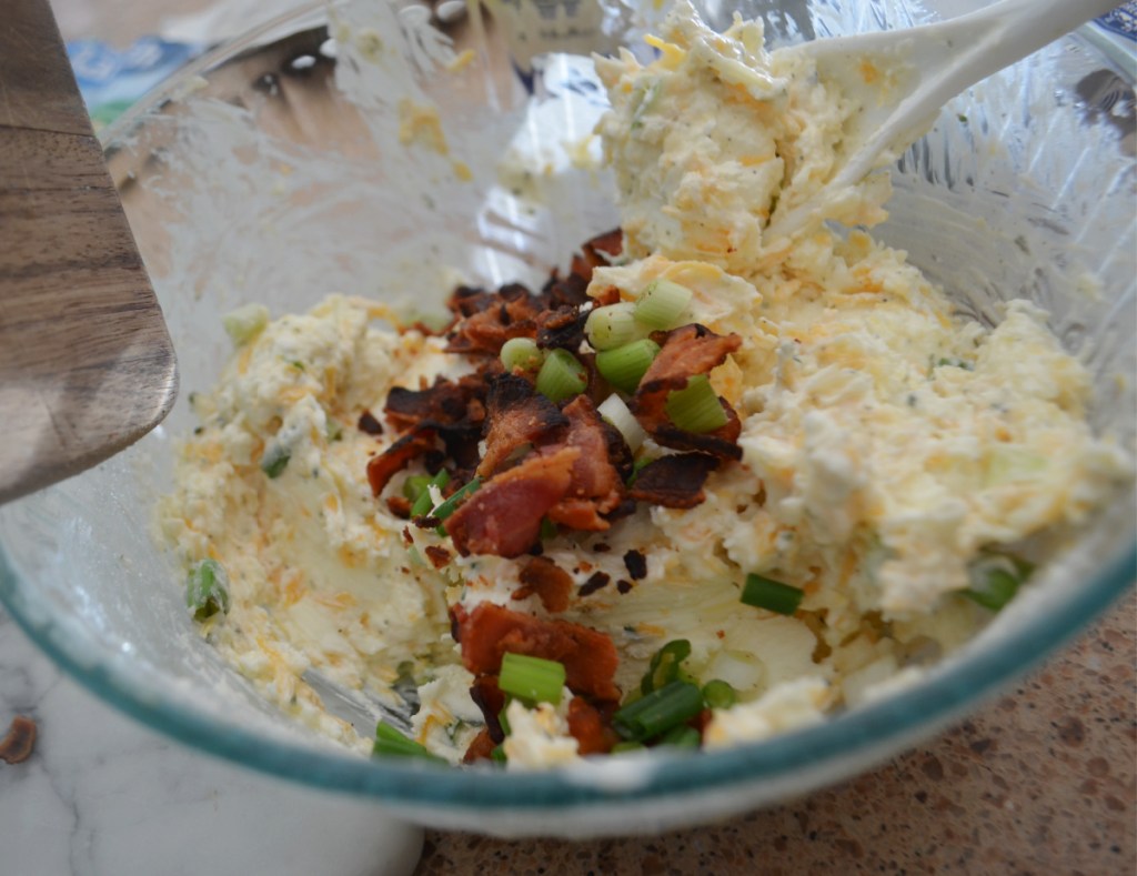 Adding bacon to a pine cone cheese ball mix