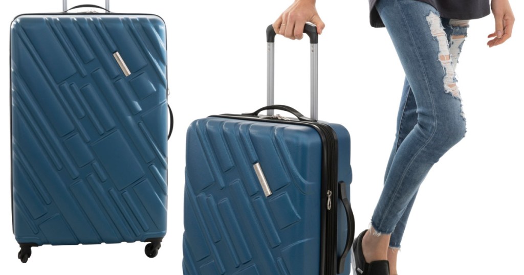 woman walking with blue suitcase and another blue suitcase