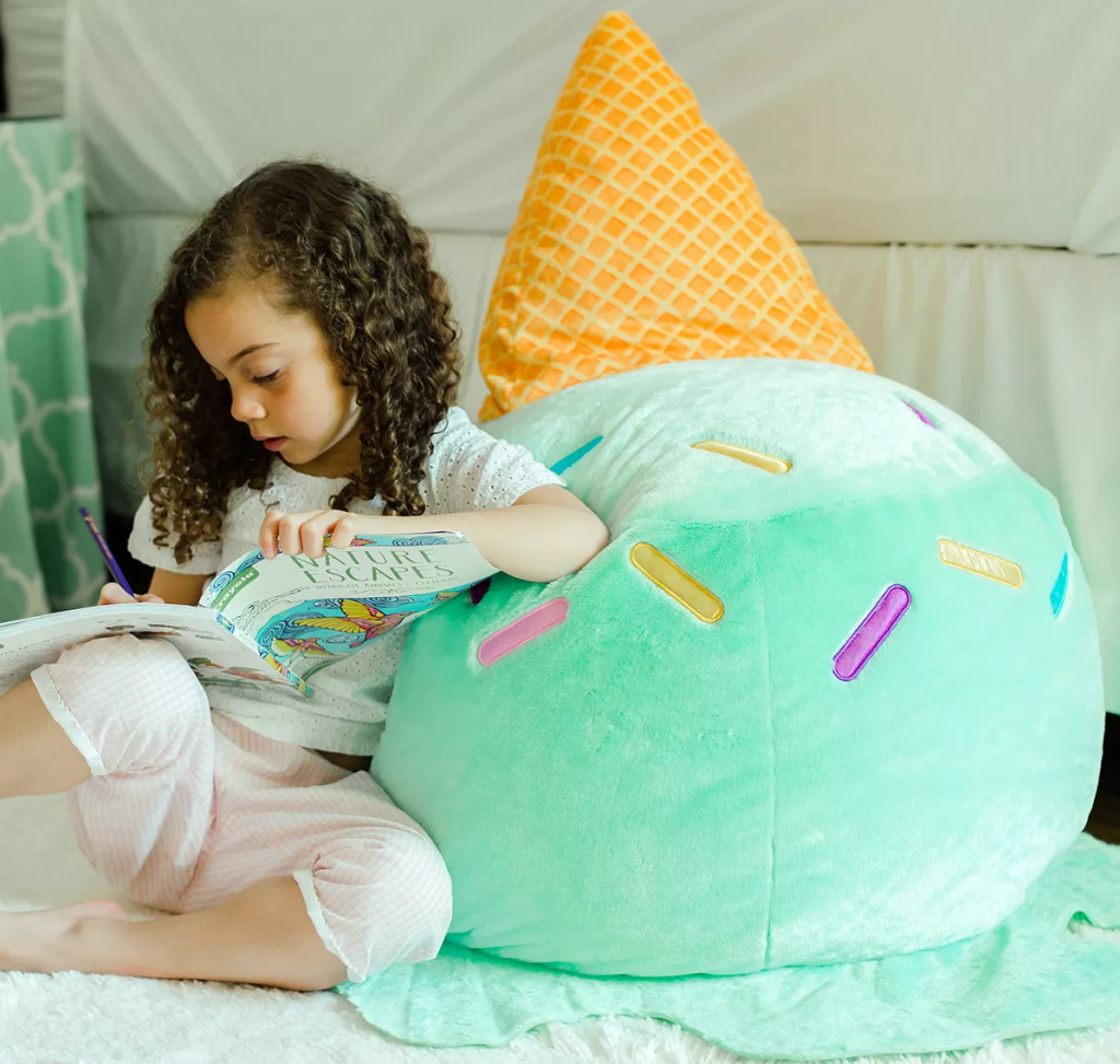 girl leaning against a bean bag chair