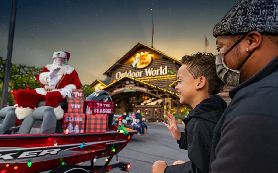 man and child outside store and Santa in sleigh