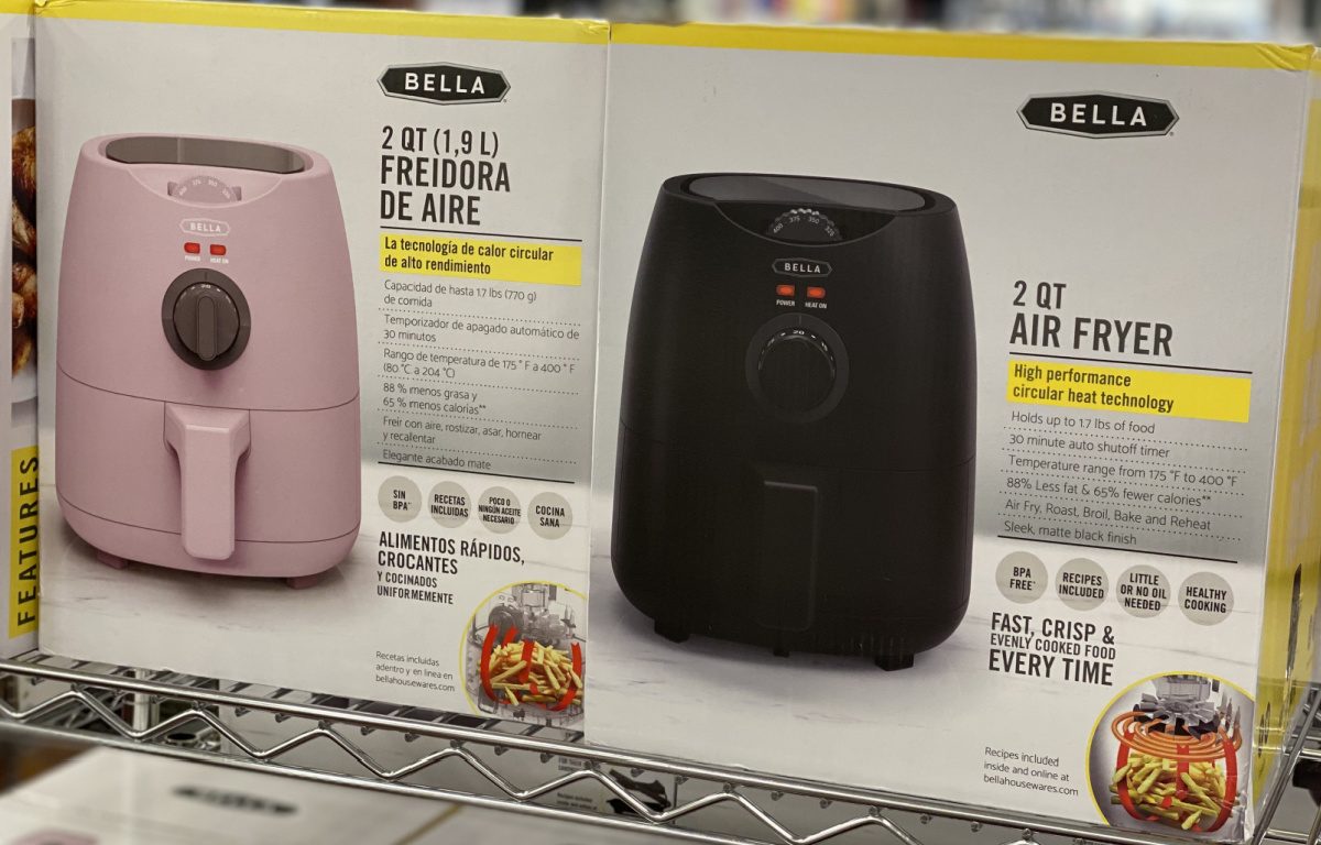 pink and black air fryers in boxes on store shelf