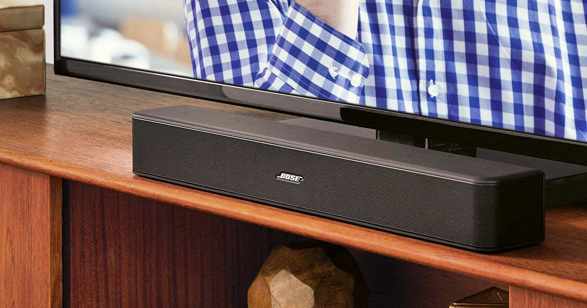 Bose Solo 5 TV Sound System on entertainment stand near TV