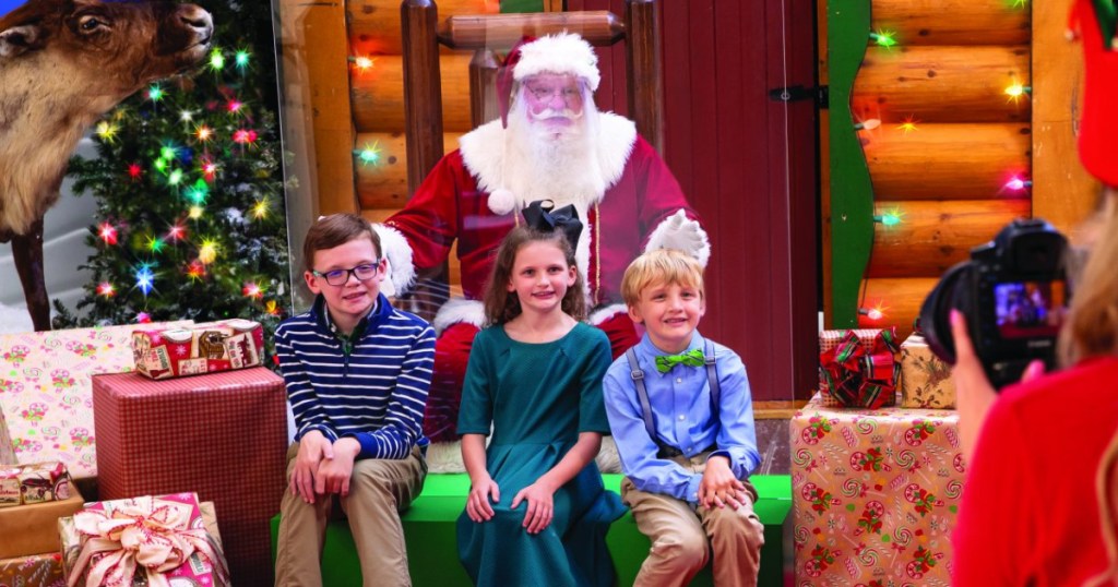 group of kids taking photo with Santa in store