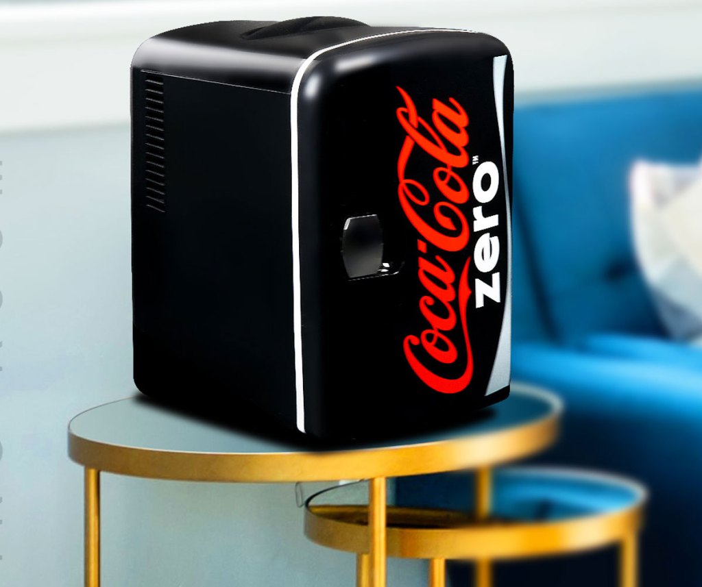 black coke zero themed mini fridge on an accent table near couch