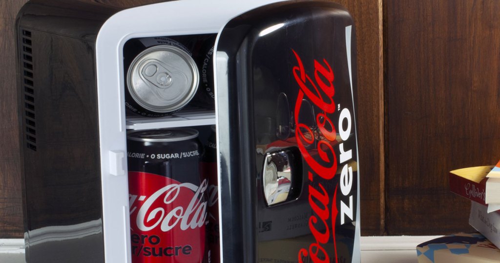 black coke zero mini fridge opening to show cans of coke zero inside
