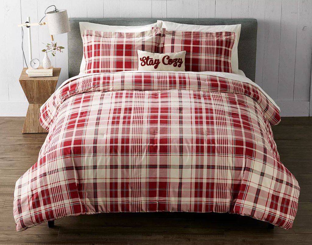 red and white plaid comforter set on a bed with matching pillow shams and coordinating throw pillow