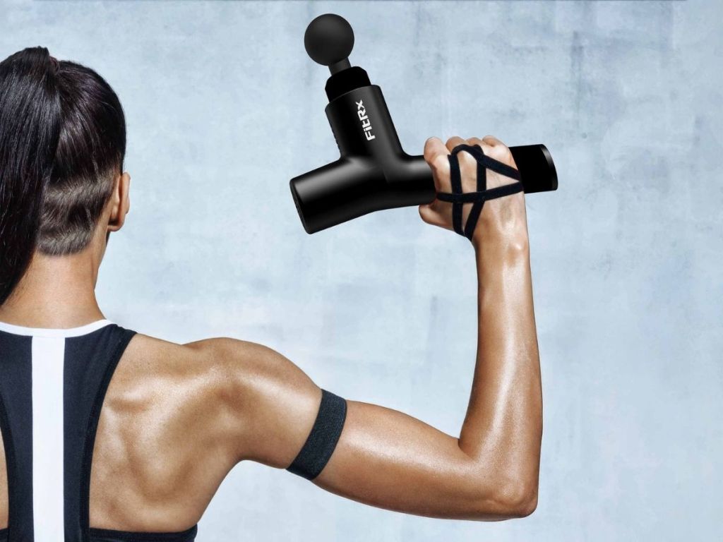 woman holding fitrx massager 