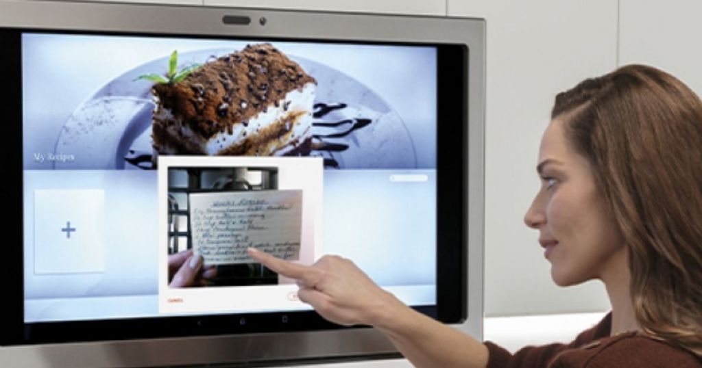 GE Profile Range Hood with lady looking at recipe on screen