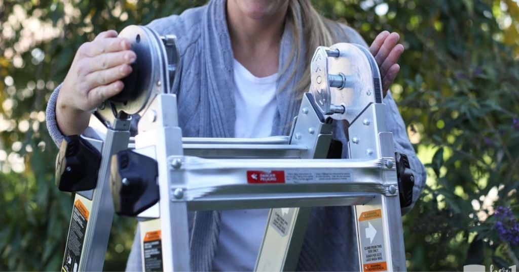 lady adjusting Gorilla 18-ft. ladder while outside