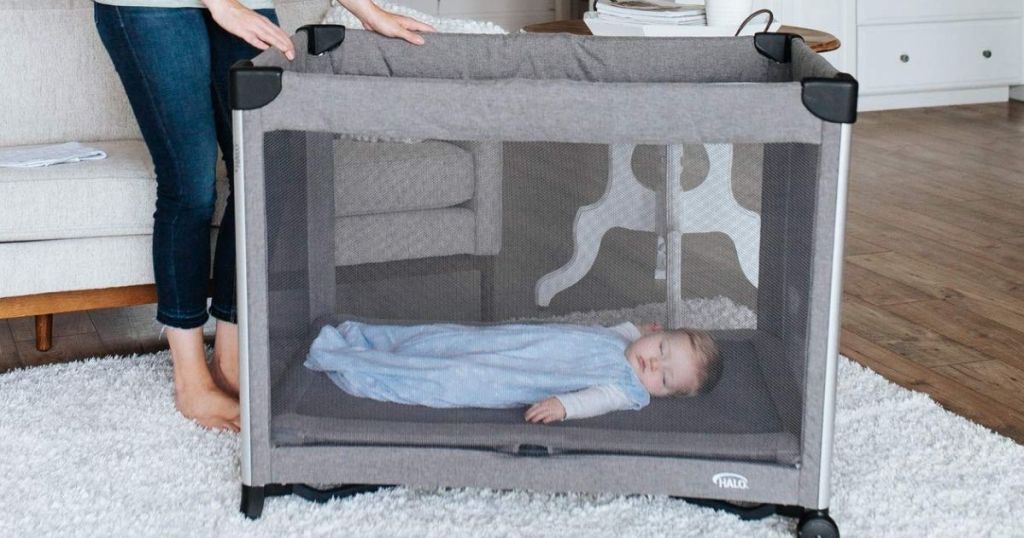 baby sleeping in a portable crib