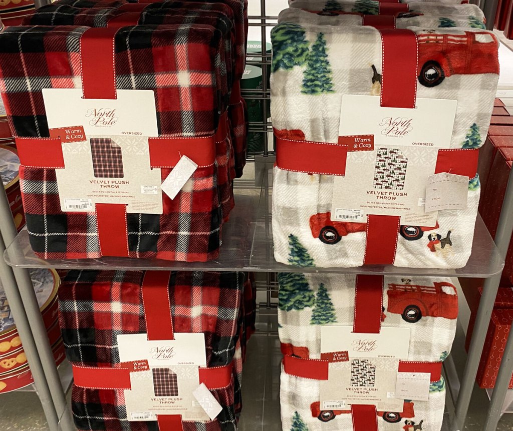 red and black plaid and red car with christmas tree print throw blankets on display at JCPenney