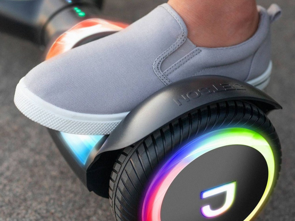 kids foot on black hoverboard with light up wheels
