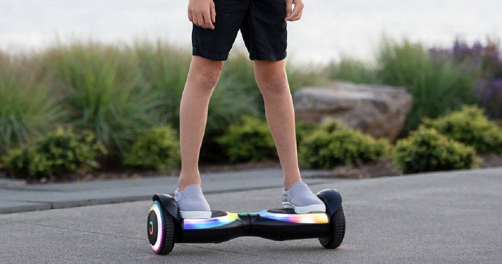 kids standing on black hoverboard with light up wheels outside