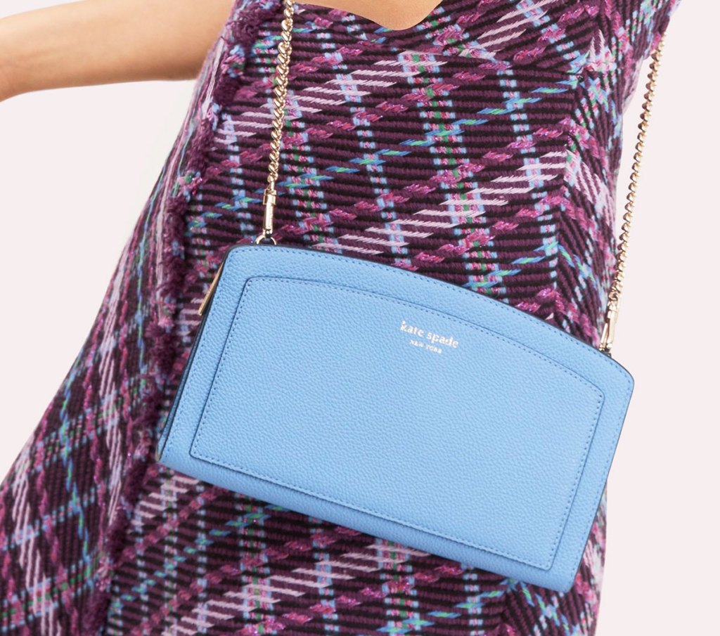 woman in black and purple plaid dress with blue crossbody kate spade bag with gold chain