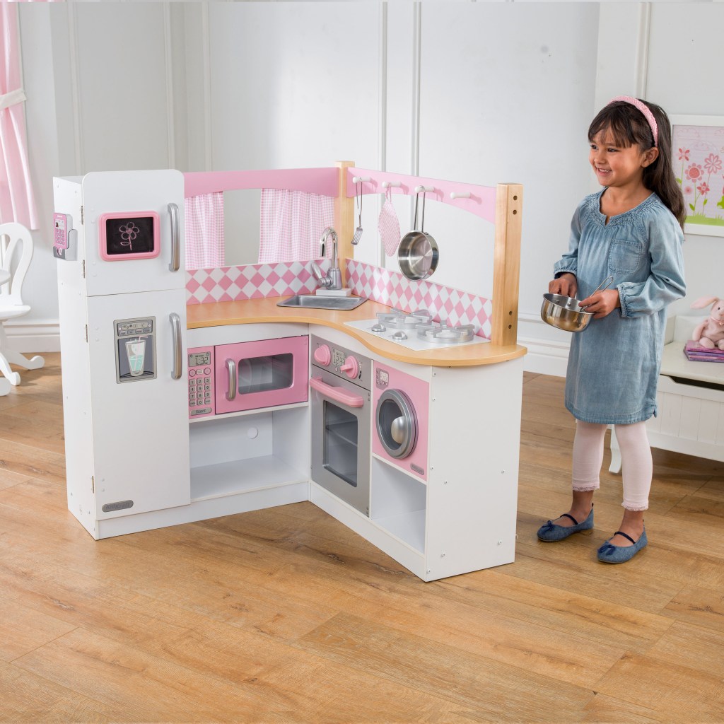 Little girl playing with Kidkraft Grand Gourmet kitchen