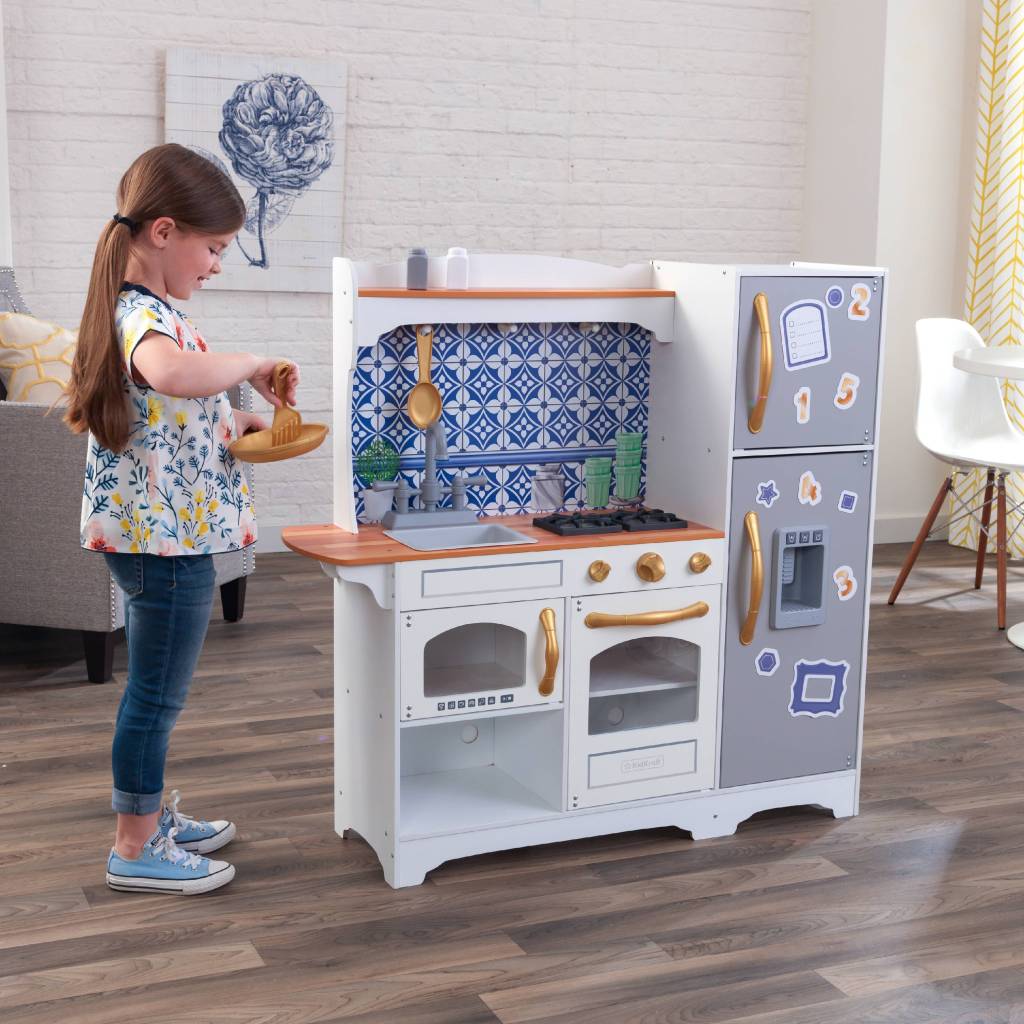 girl playing with Kidkraft mosaic Kitchen