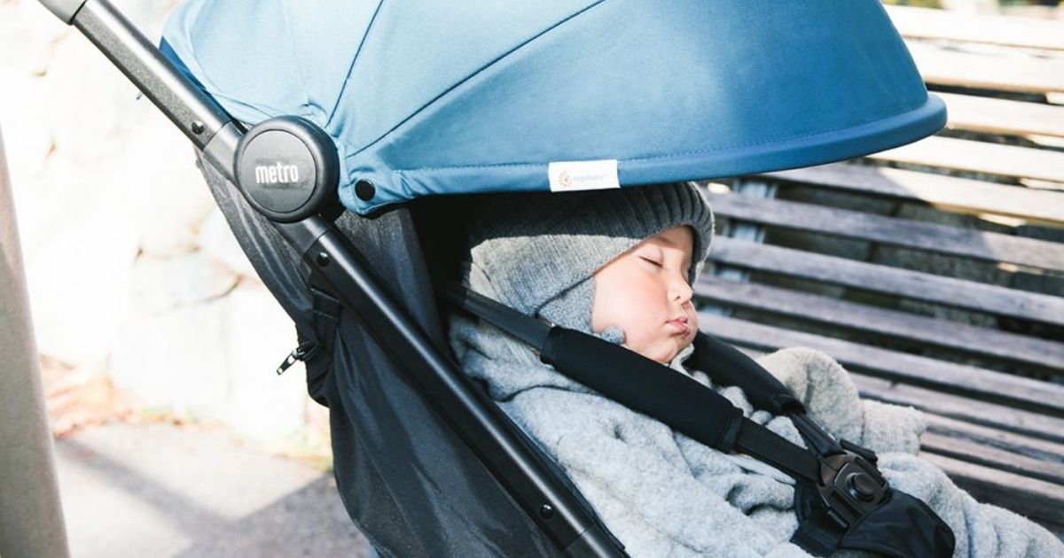 baby boy asleep in a stroller