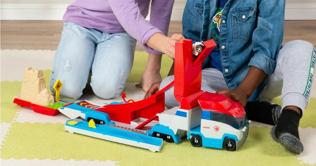 boy and girl playing with Paw Patrol Rescue Truck