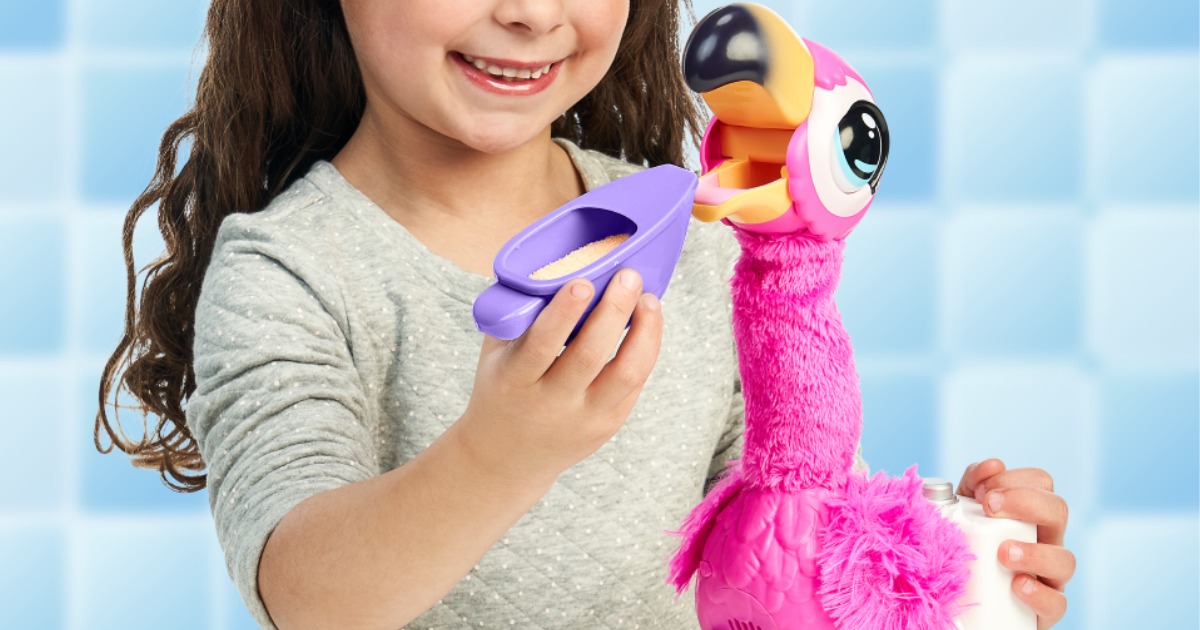 girl feeding plush flamingo