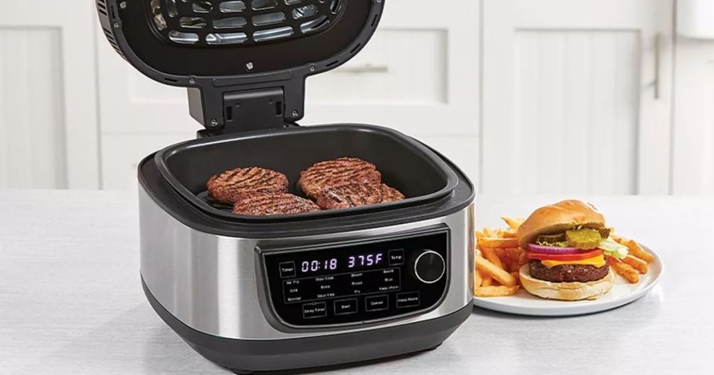 Power XL Air Fryer Grill with burgers inside and a plate with a burger next to it