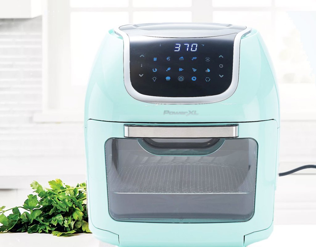 aqua colored power vortex air fryer on kitchen counter near fresh herbs