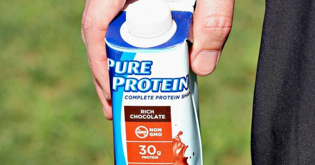 man holding a pure protein shake