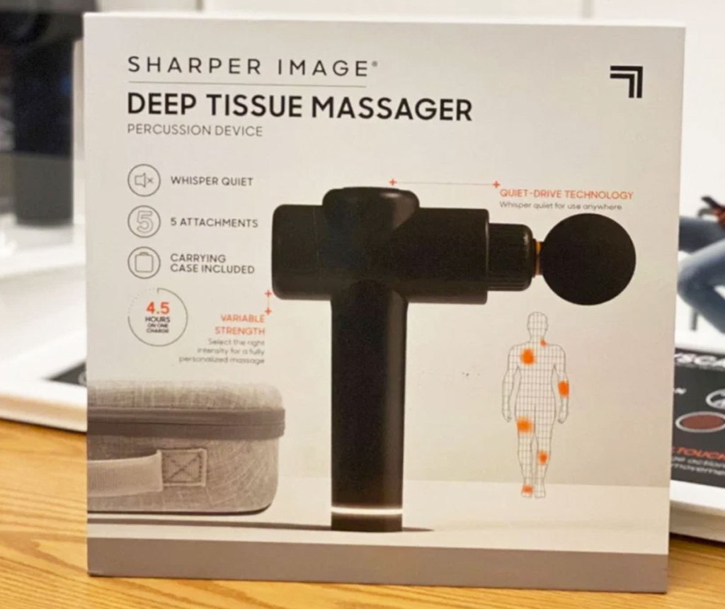 sharper image massage gun in box on a wood display table at kohl's