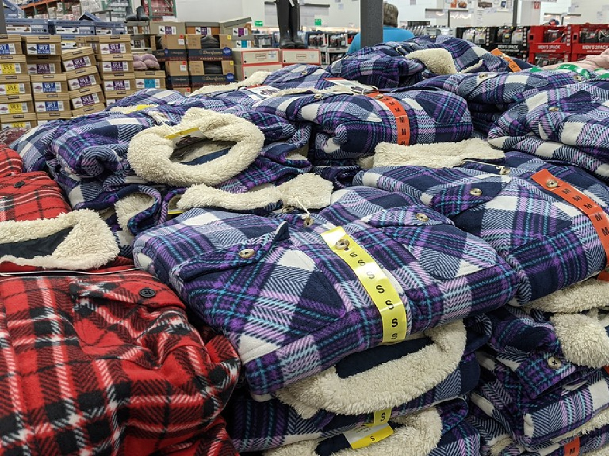 red and blue flannel jackets folded and stacked on table in store