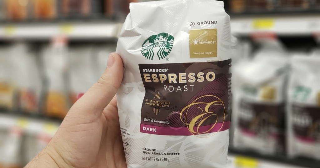 hand holding bag of espresso dark roast ground coffee in store