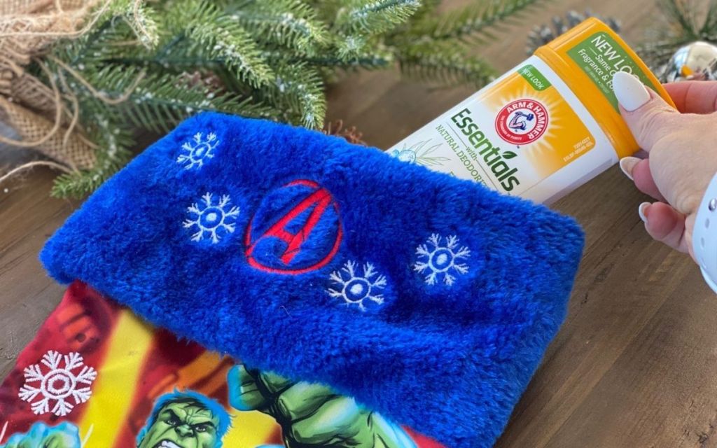 A hand placing some deodorant in a stocking