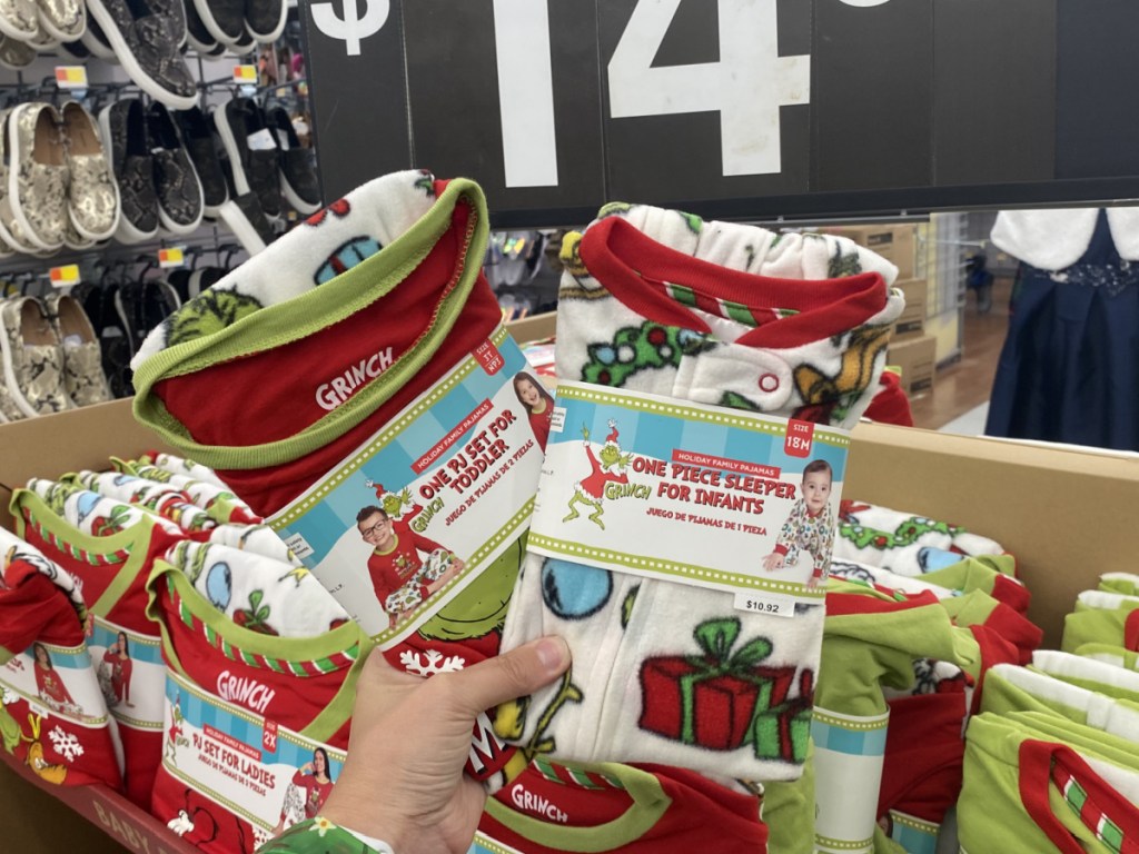 hand holding grinch infant and toddler pajamas at walmart 