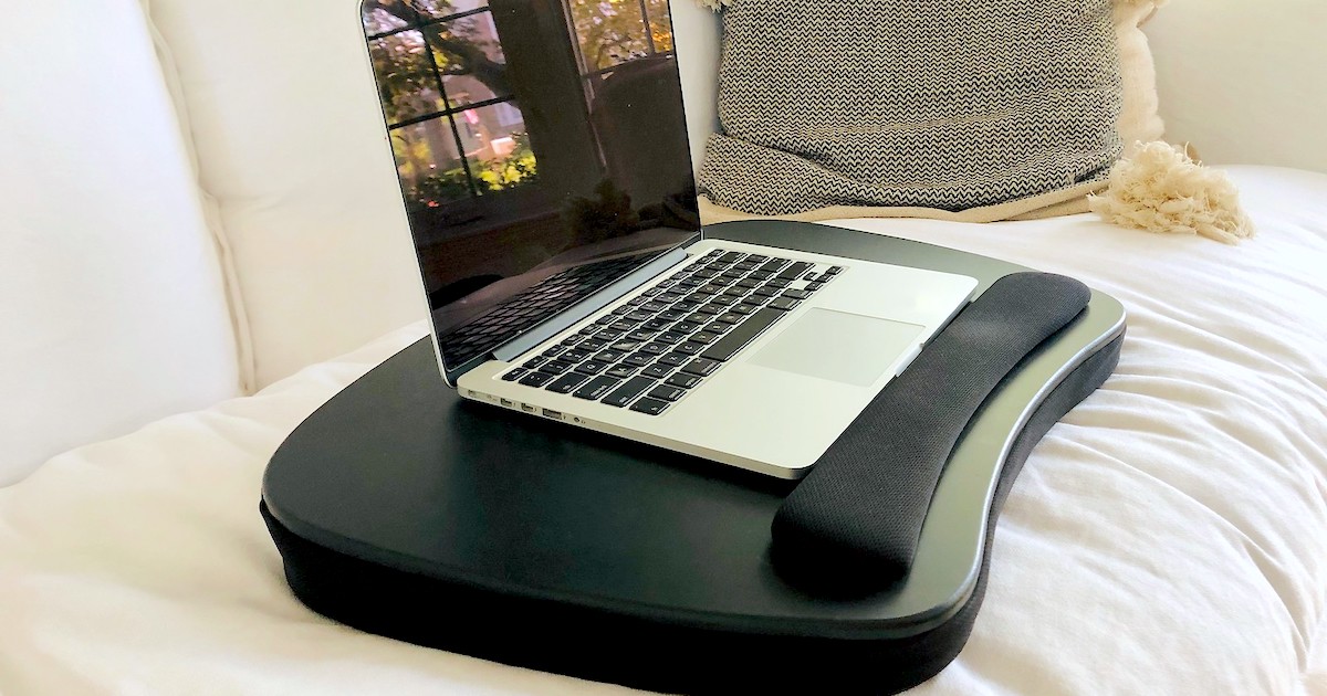 black lap desk with laptop on top sitting on white couch