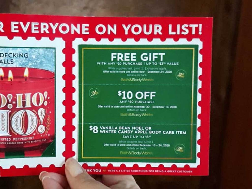 hand holding up a mailer for discounted store products