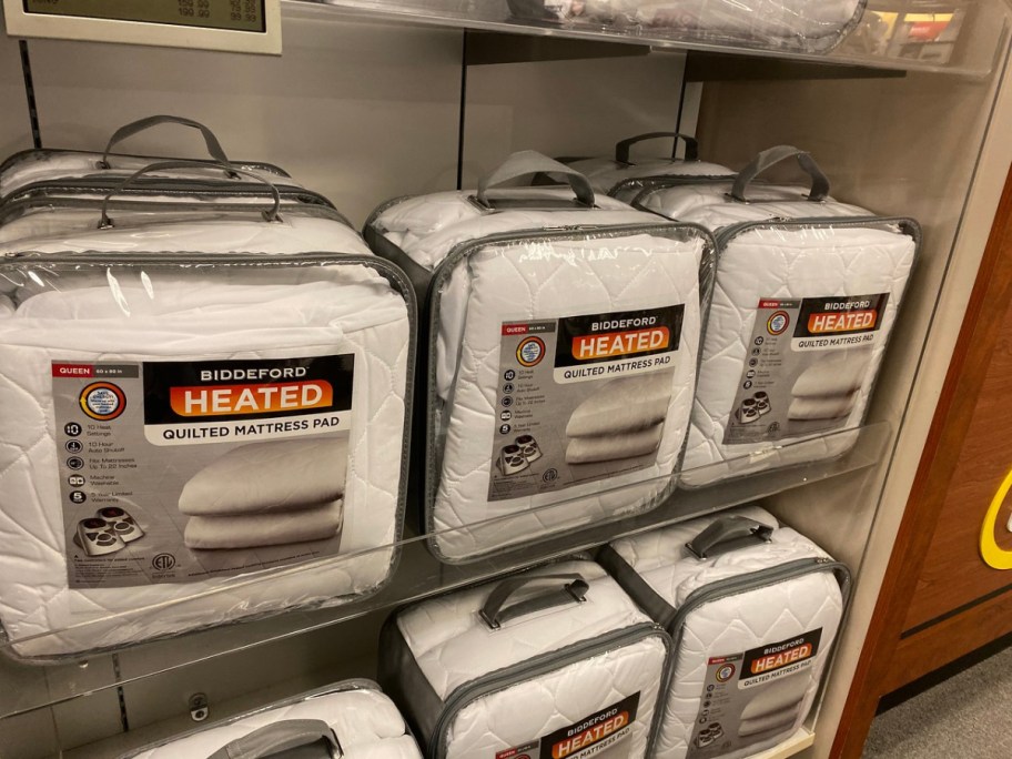 store shelf with stacks of mattress pads