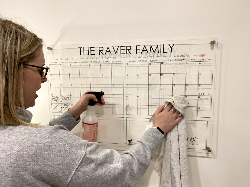 woman wiping off the Raver Family calendar