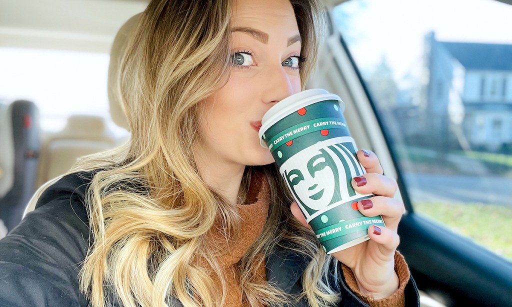 woman sipping from starbucks holiday cup