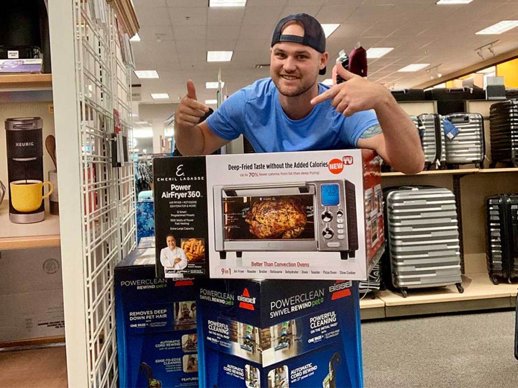 guy displaying a power air fryer in a store