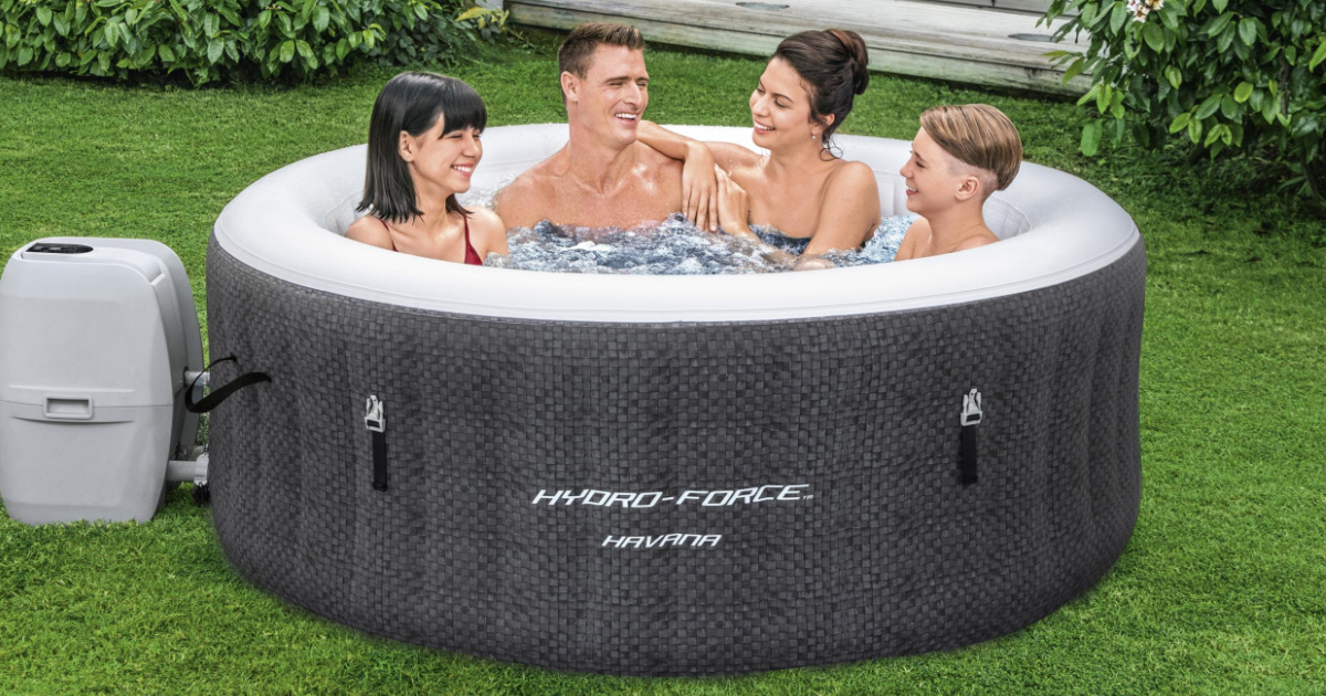 four people in hot tub on grass