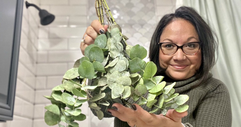 holding a bouquet of eucalyptus 