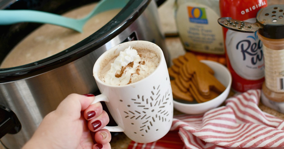 holding a cup of crockpot gingerbread latte