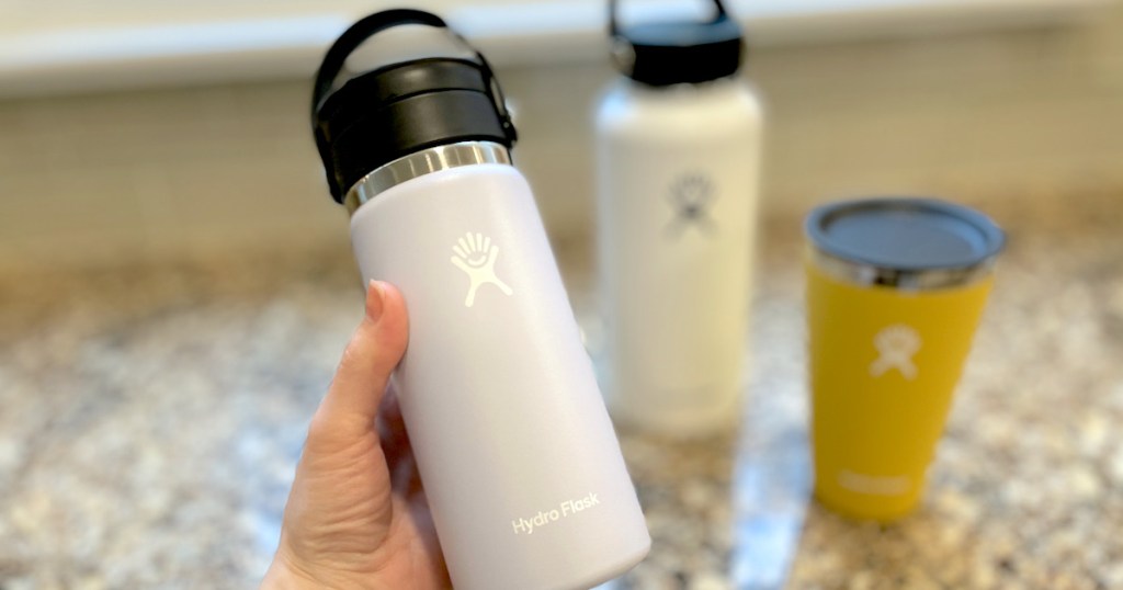 hand holding purple hydro flask coffee mug