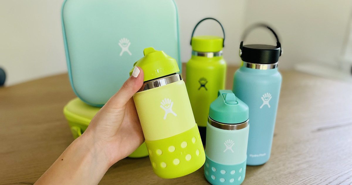 hand holding green water bottle in front of lunchboxes and hydro flask sale water bottles