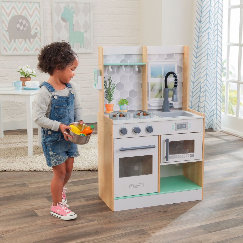 girl playing with kidkraft lets cook play kitchen