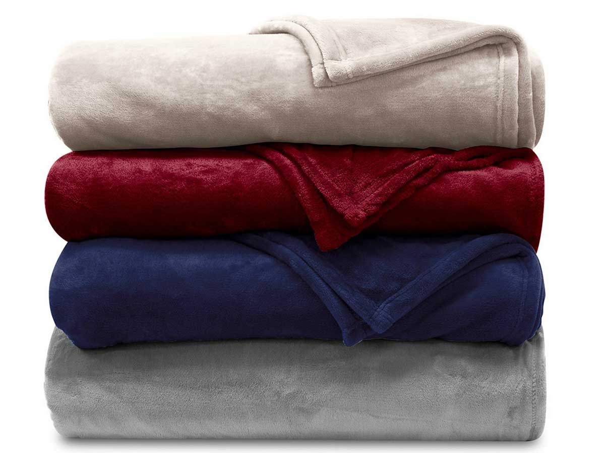 folded stack of blankets in four colors