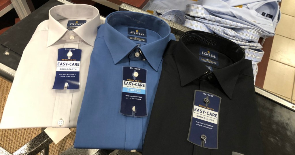 3 men's button up shirts on table in store