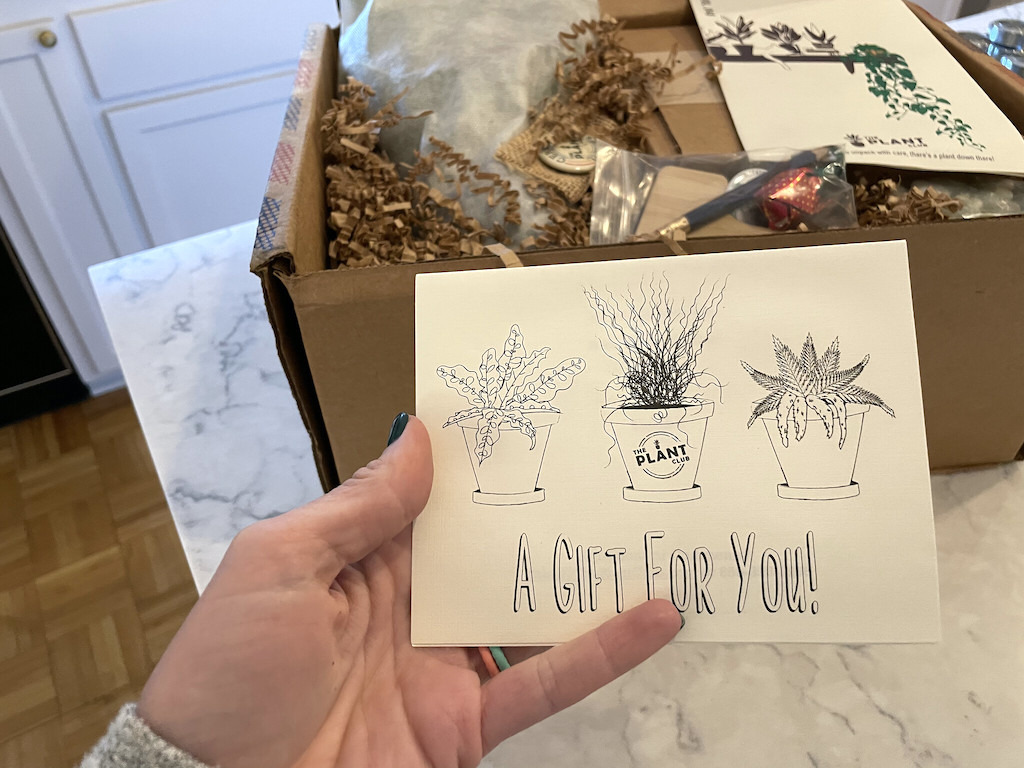 holding the gift for you card from Plant Subscription Box 