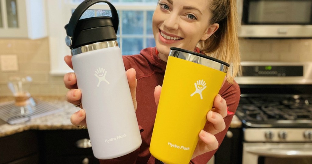 woman holding Hydro Flask bottles