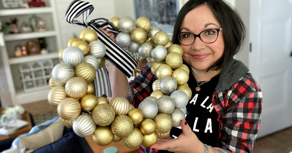 woman holding an ornament wreath - diy home decor projects