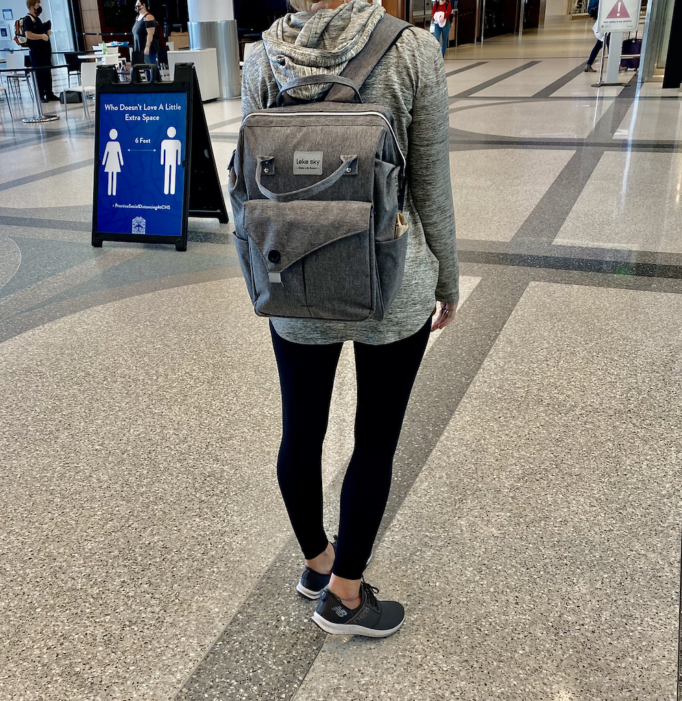 woman in the airport with travel backpack on 